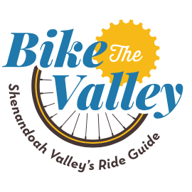 Logo of the Shenandoah Valley's Ride Guide with blue text saying Bike the Valley, displaying the graphic of a bicycle wheel behind the text.